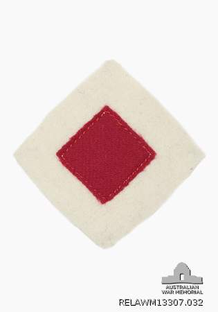 Diamond shaped colour patch for 2 Australian Divisional Cyclist Company, 2 ANZAC Cyclist Battalion and XXII Corps Cyclist Battalion, AIF, showing a central red diamond on a white background.  Worn  at the head of each sleeve.